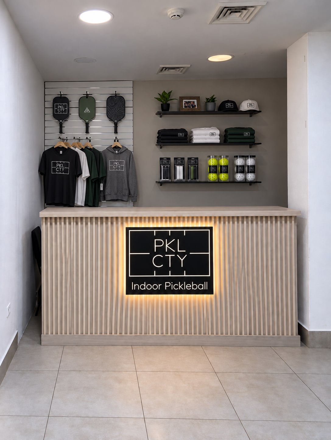 PKL CTY front desk with clothing and pickleball equipment